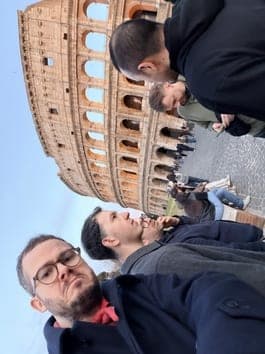 Team selfie at the Colosseum in Rome