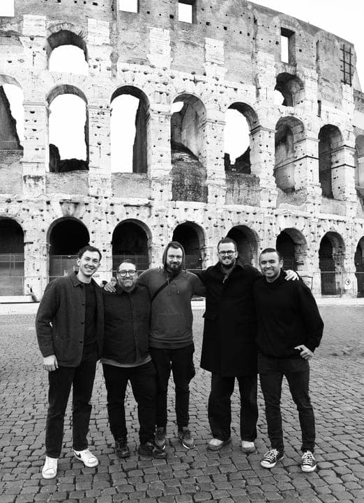 Black and white group photo in front of the Colosseum