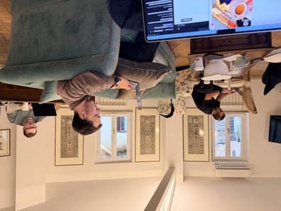 Team working from a coworking space with a teal sofa