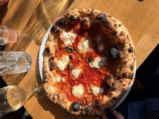 Neapolitan margherita pizza on a wooden table